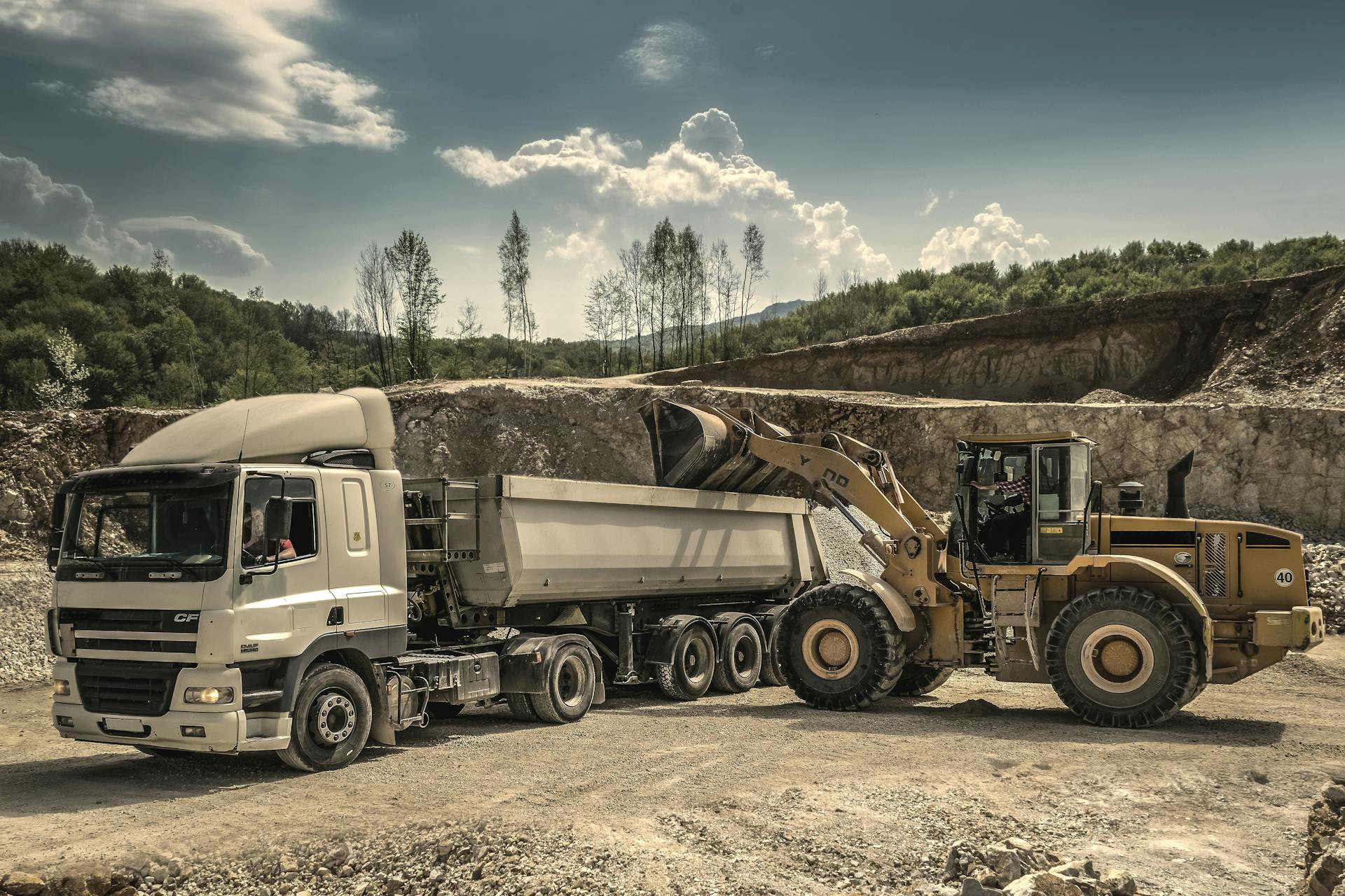 Dump truck and loader at quarry